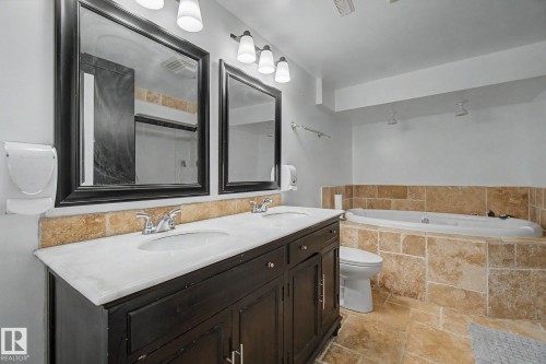 Double vanity with white countertop and integrated sinks - 242 Northmount Drive, Wetaskiwin, AB 