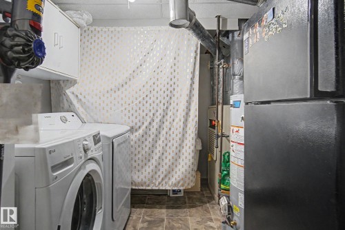Dedicated utility space featuring durable tile flooring - 242 Northmount Drive, Wetaskiwin, AB 