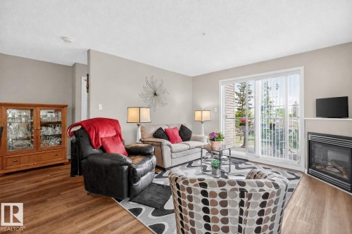203 5102 49 Avenue, Leduc, AB - Indoor Photo Showing Living Room With Fireplace