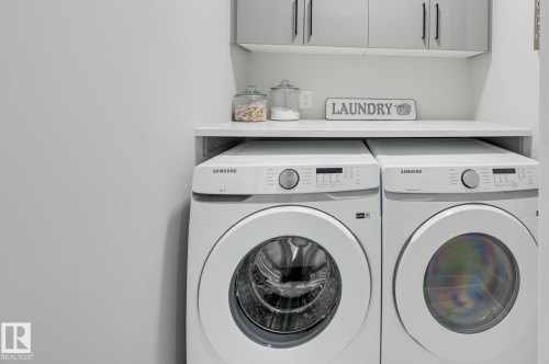 Dedicated laundry area featuring a white countertop with integrated shelving - 54 Chartres Close, St. Albert, AB - Indoor Photo Showing Laundry Room