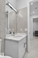 Modern vanity with a white countertop and integrated rectangular sink - 