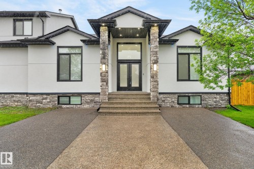 Modern-style facade featuring prominent stone columns and a double-door entry - 7304 164 Avenue, Edmonton, AB - Outdoor