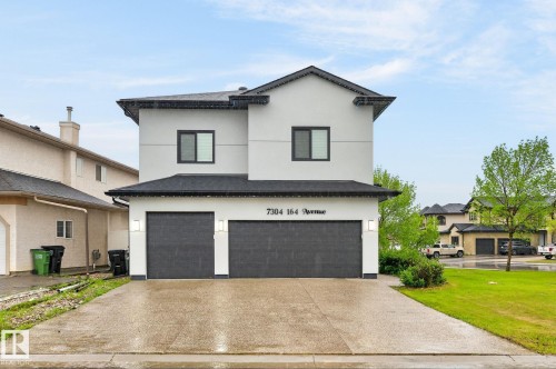 Modern two-story residence featuring a light-colored exterior with dark trim - 7304 164 Avenue, Edmonton, AB - Outdoor