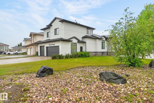 Contemporary two-story residence featuring a light-toned exterior with dark trim accents - 7304 164 Avenue, Edmonton, AB - Outdoor