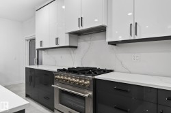 Professional-grade stainless steel range with a coordinating range hood, set against a full-height backsplash with subtle veining - 