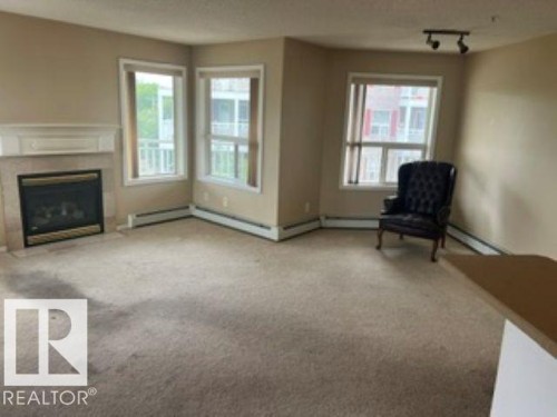 415 10951 124 Street, Edmonton, AB - Indoor Photo Showing Other Room With Fireplace