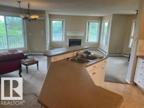 415 10951 124 Street, Edmonton, AB - Indoor Photo Showing Other Room With Fireplace