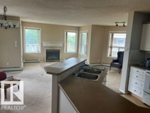 415 10951 124 Street, Edmonton, AB - Indoor With Fireplace