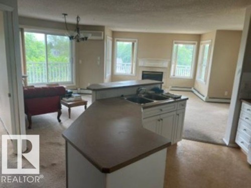 415 10951 124 Street, Edmonton, AB - Indoor Photo Showing Living Room With Fireplace