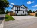 Contemporary two-story residence with white vertical siding and black trim accents - 12160 93 Street Nw, Edmonton, AB 