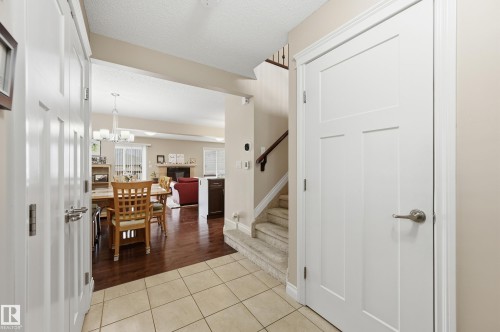 Front entry with tiled flooring and a white paneled door - 1111 176 Street, Edmonton, AB 
