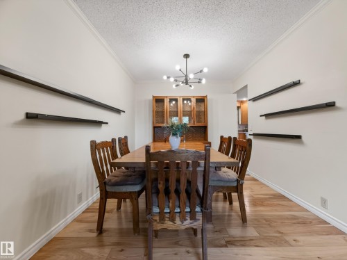 Dining space featuring wood-finish flooring and crown molding - 18416 90 Avenue, Edmonton, AB 