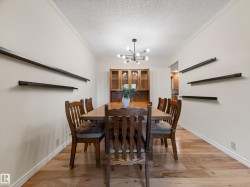 Dining space featuring wood-finish flooring and crown molding - 