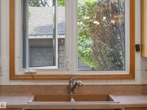 Double-basin sink with a chrome faucet, set into a composite countertop - 18416 90 Avenue, Edmonton, AB 