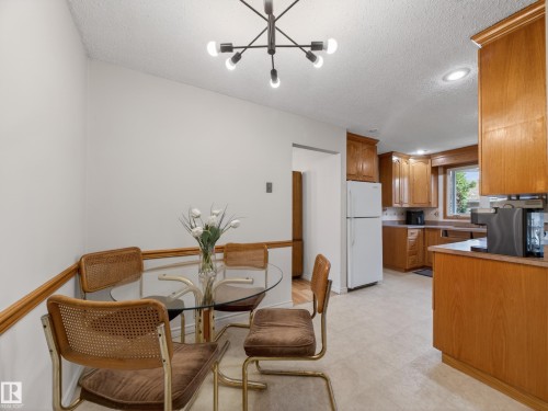 Dining area featuring a contemporary sputnik chandelier and a chair rail molding - 18416 90 Avenue, Edmonton, AB 