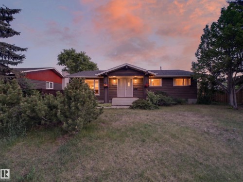 Ranch-style residence featuring dark brown siding and a dark shingle roof - 18416 90 Avenue, Edmonton, AB 