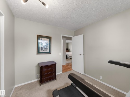 Carpeted interior room with neutral wall paint and white trim - 18416 90 Avenue, Edmonton, AB 