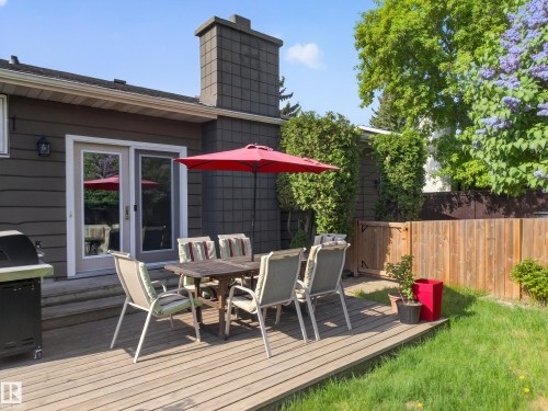 Expansive wood-finish deck with direct access to the interior via a glass sliding door - 18416 90 Avenue, Edmonton, AB 