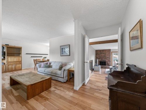 Hardwood-style flooring extends through the main living area - 18416 90 Avenue, Edmonton, AB 