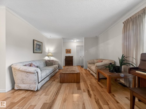 Light wood-finish flooring extending across the room - 18416 90 Avenue, Edmonton, AB 