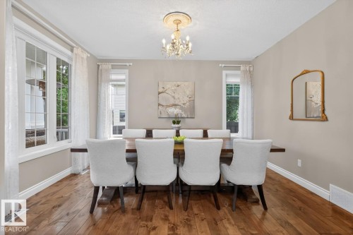 Formal Dining Room Space featuring room for 8+ Guests, North and East Facing Windows, and Chandelier - 5016 213 Street, Edmonton, AB 