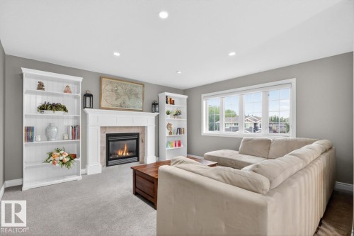 Upstairs Bonus Room featuring Gas Fireplace, North Facing Windows, and ample space for a playroom and movie nights - 5016 213 Street, Edmonton, AB 