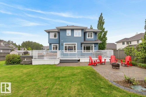Large South Facing Backyard Space (1259 m@ / 0.31 Acres) featuring Apple Trees, Pear Trees, Cherry Trees, Berry Bushes, Irrigation System, Fire Pit, and Fountain - 5016 213 Street, Edmonton, AB 