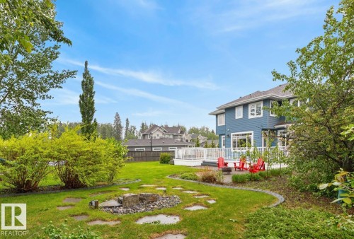 Large South Facing Backyard Space (1259 m@ / 0.31 Acres) featuring Apple Trees, Pear Trees, Cherry Trees, Berry Bushes, Irrigation System, Fire Pit, and Fountain - 5016 213 Street, Edmonton, AB 