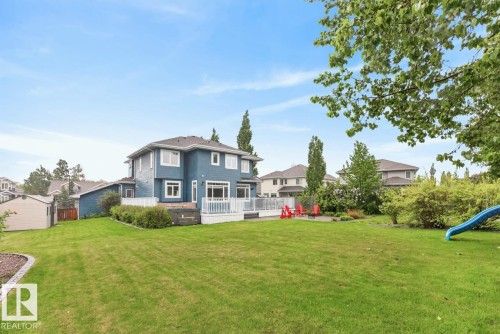 Large South Facing Backyard Space (1259 m@ / 0.31 Acres) featuring Apple Trees, Pear Trees, Cherry Trees, Berry Bushes, Irrigation System, Fire Pit, and Fountain - 5016 213 Street, Edmonton, AB 
