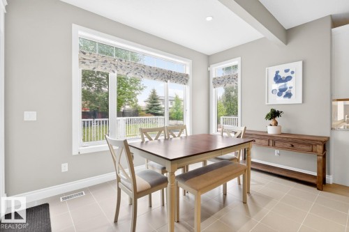 Open-concept dining area featuring a large South West Facing Window and Rear Deck Access - 5016 213 Street, Edmonton, AB 