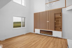 Integrated media center with wood-finish paneling, an electric fireplace, and built-in display shelving - 