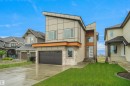 Contemporary exterior featuring a flat roofline and multi-toned facade - 142 Edgewater Circle, Leduc, AB 