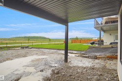 Covered patio space featuring a corrugated metal ceiling and structural post - 