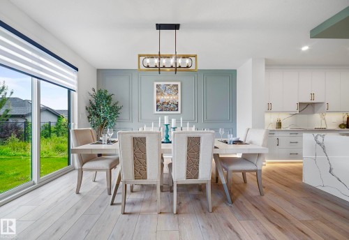 Dining area featuring wood-finish flooring, a contemporary linear chandelier, and a decorative paneled accent wall - 16607 8 Street, Edmonton, AB 