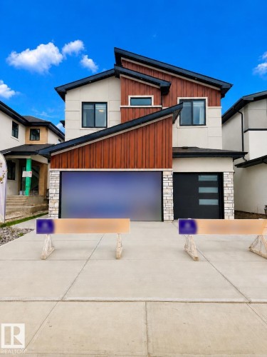Modern architectural facade featuring multi-tone vertical siding and stone accents - 16607 8 Street, Edmonton, AB 
