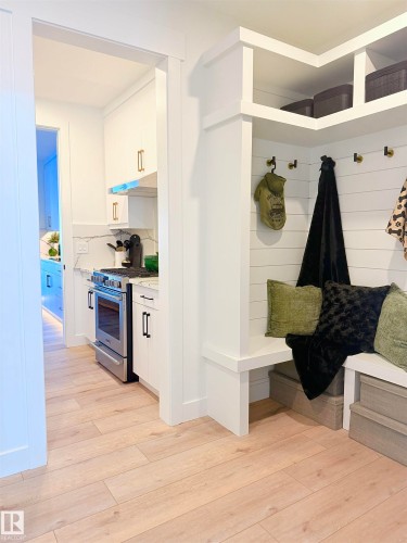 Built-in entryway bench with upper shelving and coat hooks - 16607 8 Street, Edmonton, AB 