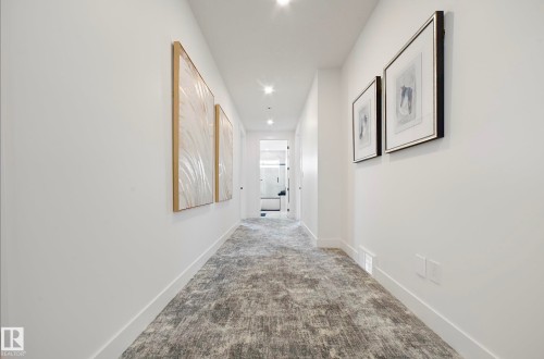 White-painted walls featuring recessed lighting, a patterned grey runner, and white trim - 16607 8 Street, Edmonton, AB 