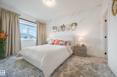 Spacious room featuring a large window with roller shades, decorative wall paneling, a recessed ceiling light, and a built-in door - 16607 8 Street, Edmonton, AB 