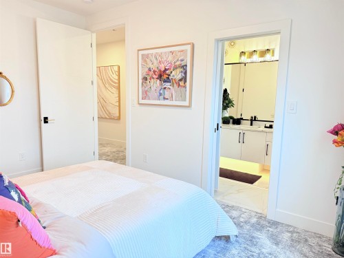 Bedroom entry featuring a white paneled door with black hardware - 16607 8 Street, Edmonton, AB 