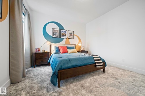 White wall space featuring a decorative accent wall with blue and gold circular patterns - 16607 8 Street, Edmonton, AB 