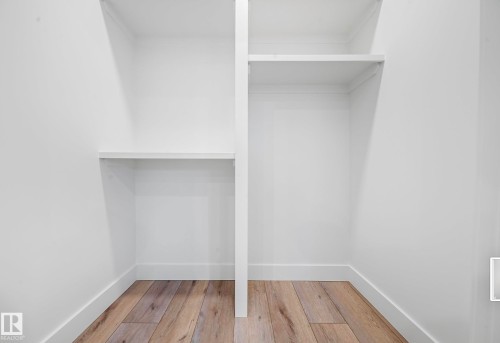 Built-in white shelving with wood-finish flooring - 16607 8 Street, Edmonton, AB 