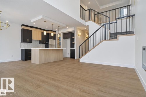 Open-concept living space featuring wood-finish flooring - 19 Rosa Crescent, St. Albert, AB 