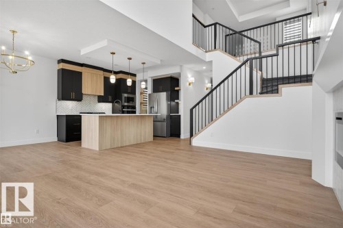 Open-concept living area featuring wood-finish flooring throughout - 19 Rosa Crescent, St. Albert, AB 