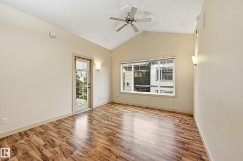 Room featuring wood-finish flooring, a vaulted ceiling, and a ceiling fan - 50 2565 Hanna Crescent, Edmonton, AB 