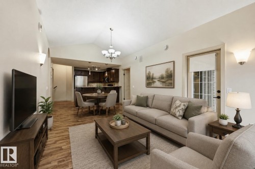 Open-concept living space featuring vaulted ceilings and wood-finish flooring - 50 2565 Hanna Crescent, Edmonton, AB 
