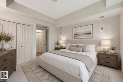 Carpeted bedroom featuring bi-fold closet doors, recessed lighting, and a textured area rug - 