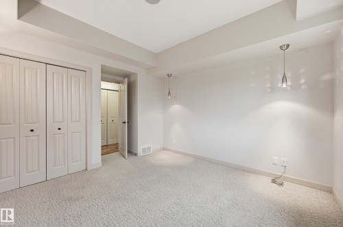 Spacious room featuring light-toned carpeting and neutral wall tones - 50 2565 Hanna Crescent, Edmonton, AB 