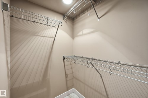 Walk-in closet featuring light-colored walls, recessed ceiling lighting, and multiple levels of wire shelving for storage - 50 2565 Hanna Crescent, Edmonton, AB 