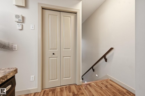 Paneled bi-fold door with black hardware - 50 2565 Hanna Crescent, Edmonton, AB 