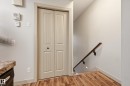 Paneled bi-fold door with black hardware - 50 2565 Hanna Crescent, Edmonton, AB 